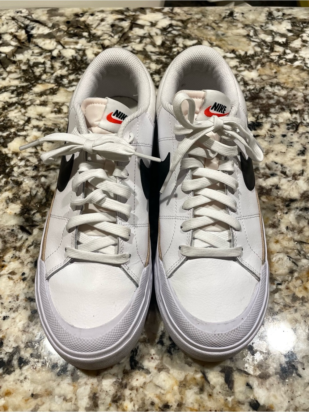 Nike Women’s White Sneakers with Black Swoosh and Orange Tongue Logo